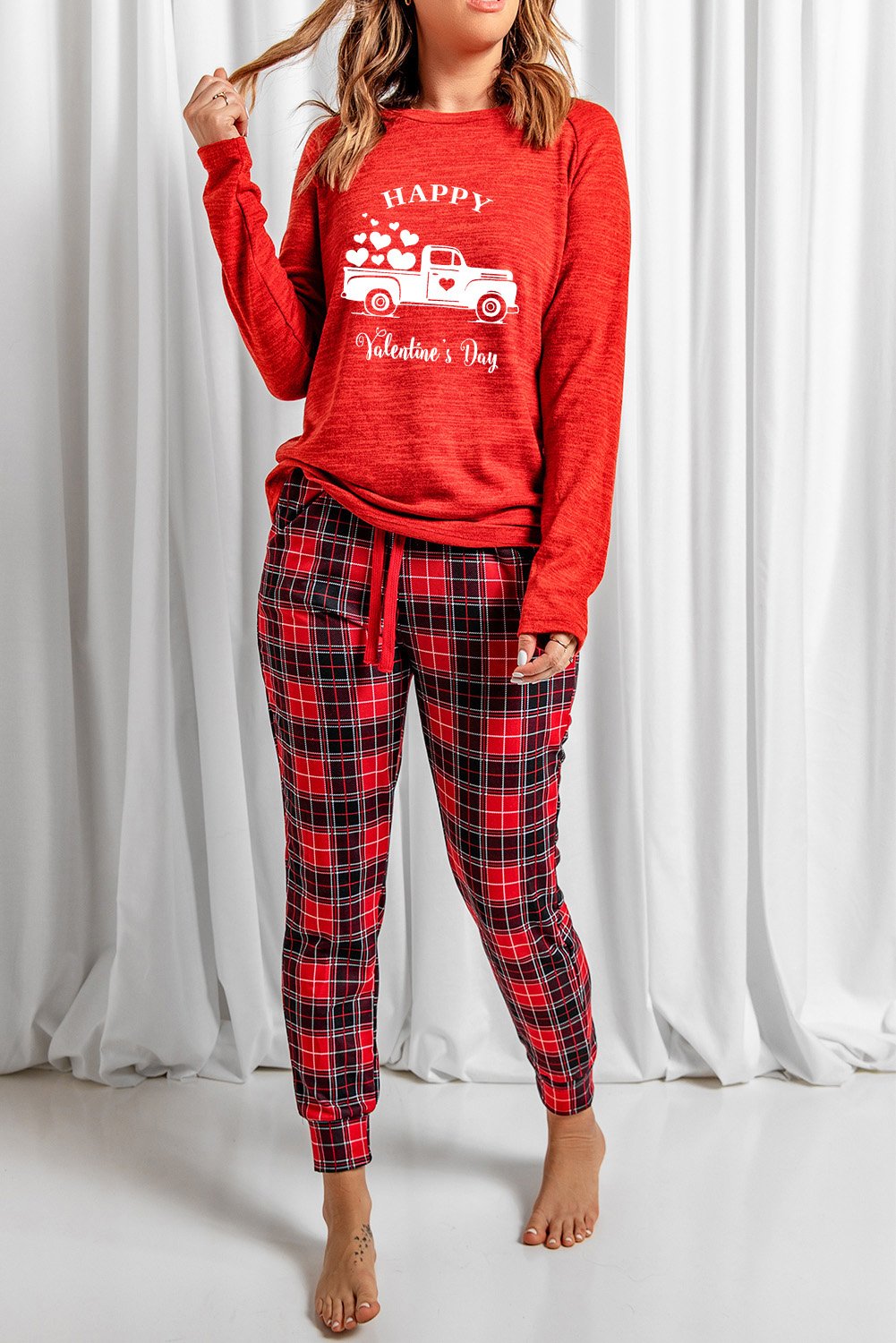 A cozy red lounge set featuring a plaid print, consisting of a full-sleeve top and matching pants, perfect for Valentine's Day and winter lounging.