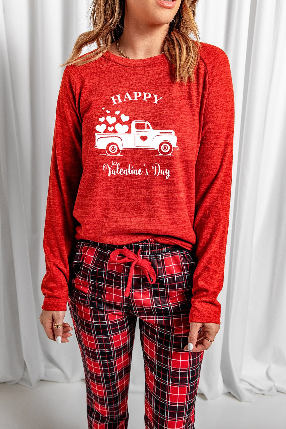 A cozy red lounge set featuring a plaid print, consisting of a full-sleeve top and matching pants, perfect for Valentine's Day and winter lounging.