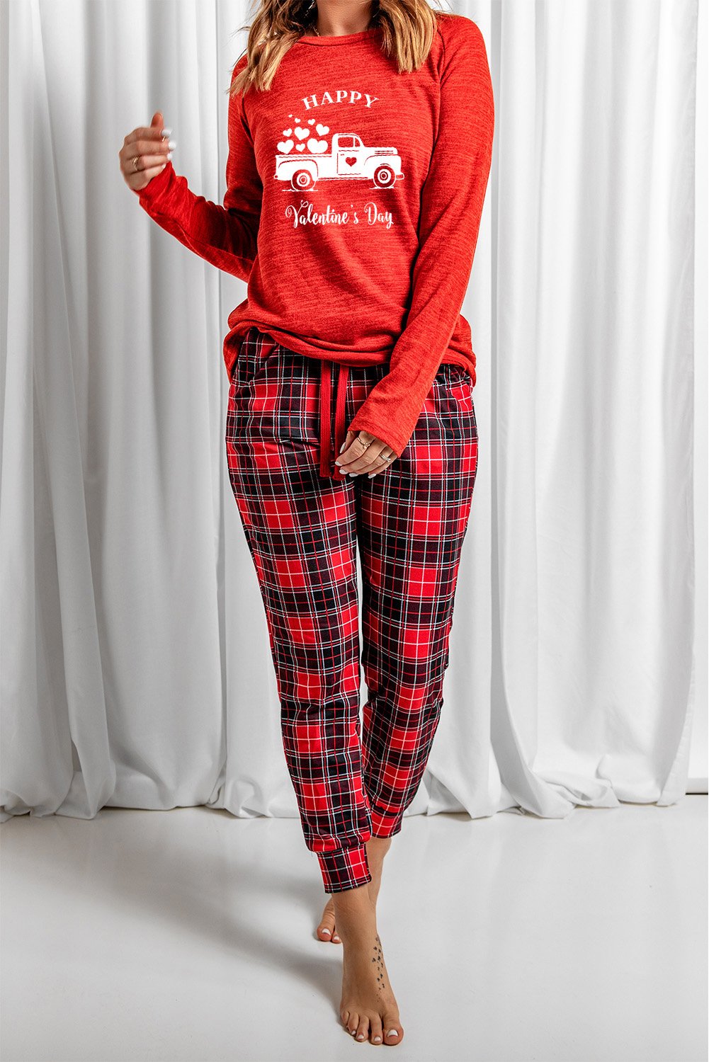 A cozy red lounge set featuring a plaid print, consisting of a full-sleeve top and matching pants, perfect for Valentine's Day and winter lounging.