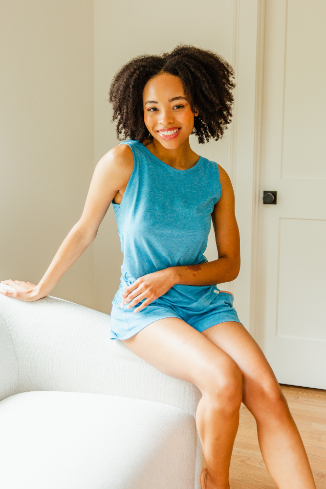 Pima Sleeveless Tee Short Set displayed on a model, showcasing the flattering boat-neckline and soft organic cotton fabric in a stylish blue color.