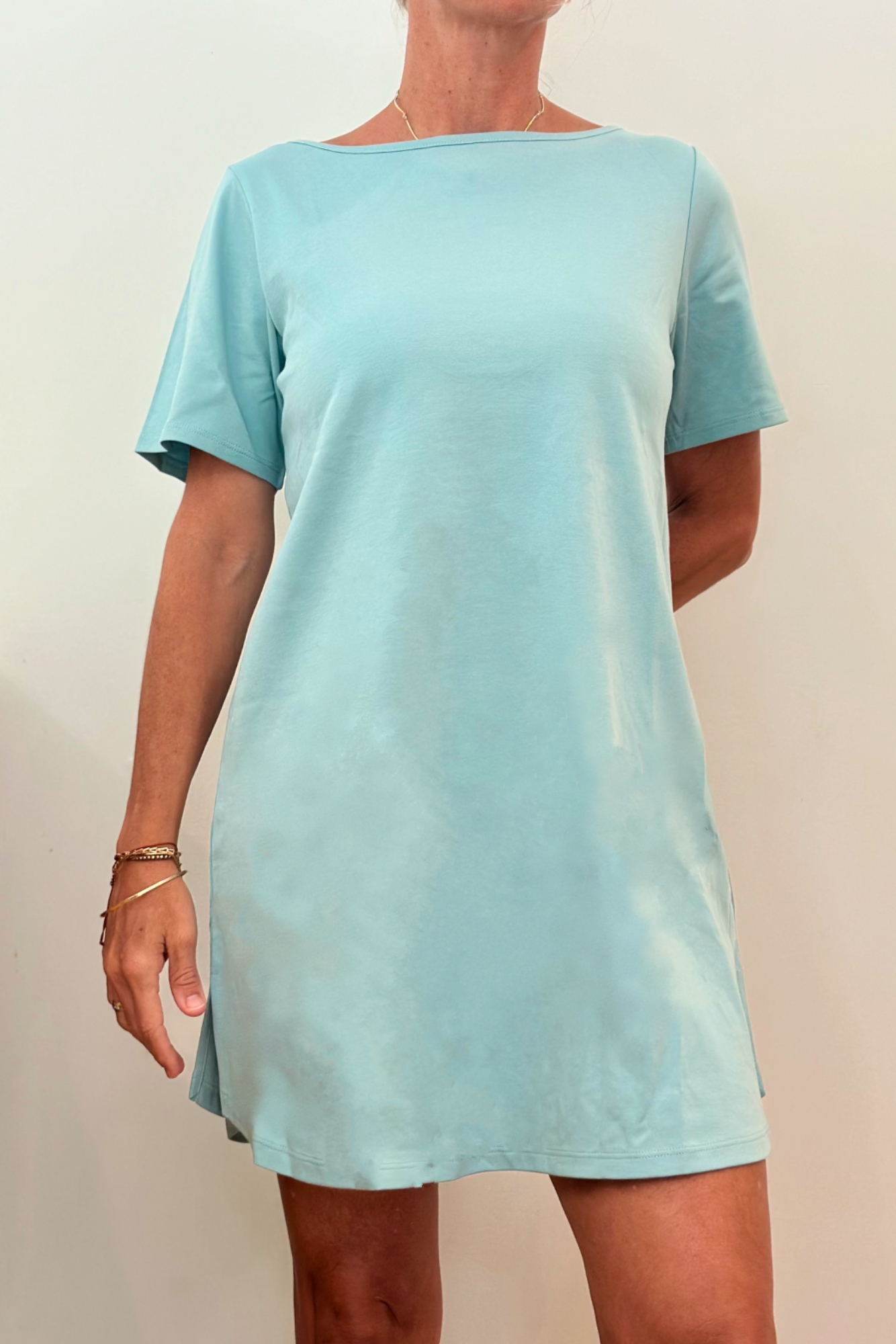 A stylish Women's Organic Pima Cotton T-Shirt Dress featuring an accent stripe down the back, modeled by a woman in dusk color.