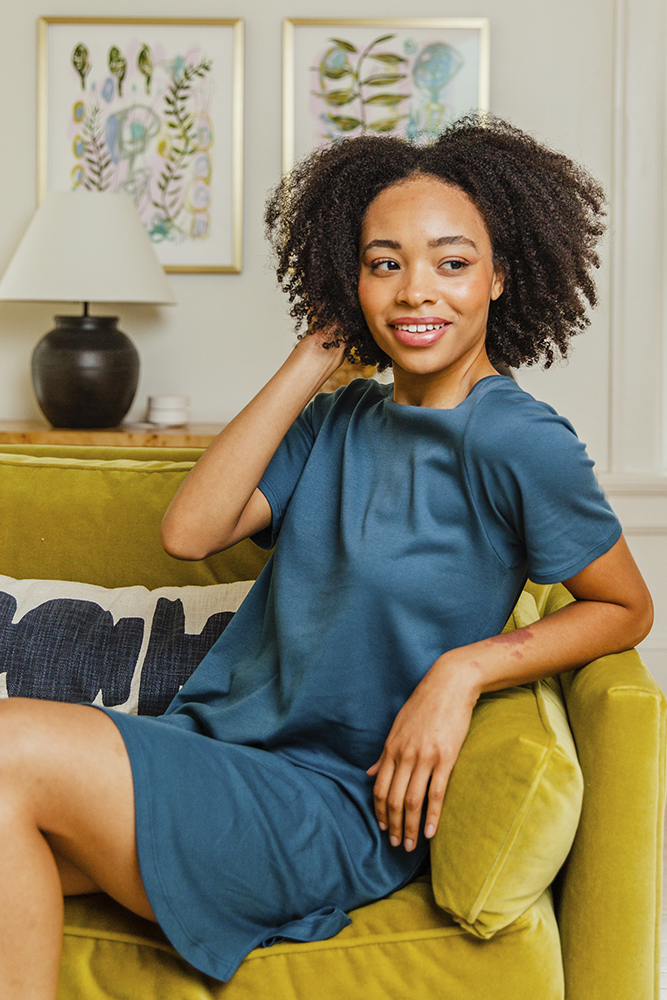 A stylish Women's Organic Pima Cotton T-Shirt Dress featuring an accent stripe down the back, modeled by a woman in dusk color.