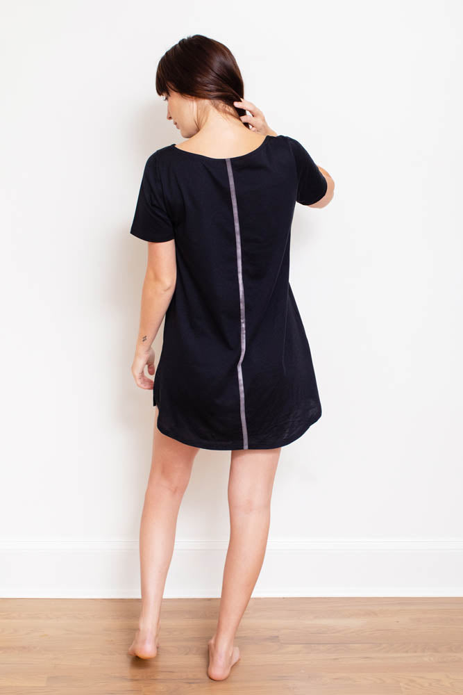 A stylish Women's Organic Pima Cotton T-Shirt Dress featuring an accent stripe down the back, modeled by a woman in dusk color.