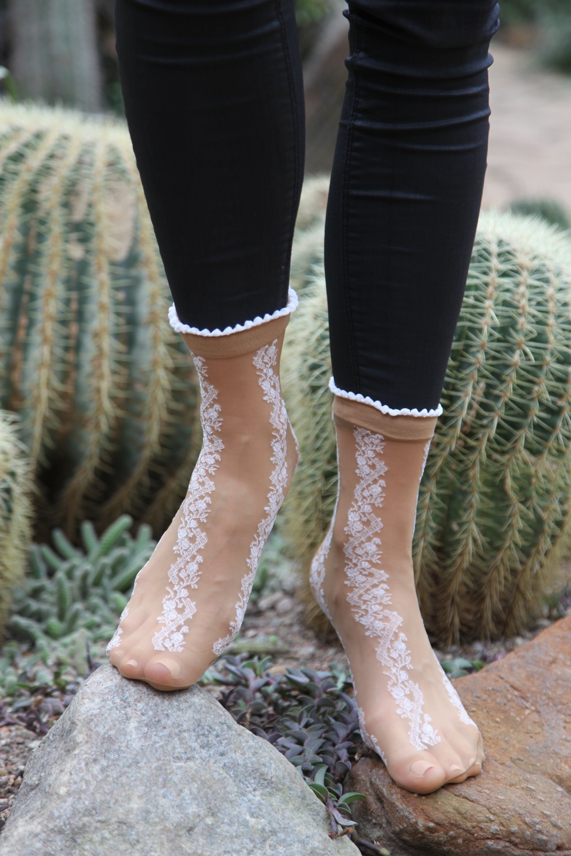 A pair of ADELE 20DEN sheer beige socks with a stylish pattern, showcasing their elegant design and soft texture.