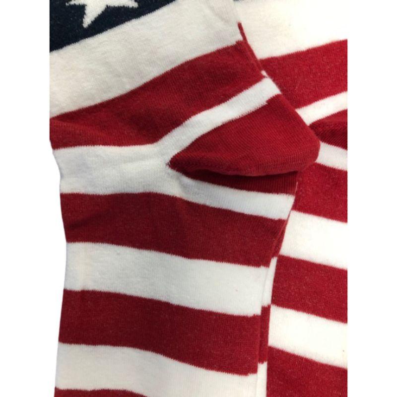 A pair of American Flag Patriotic Socks featuring vibrant red, white, and blue colors with stars and stripes, made from premium quality cotton.