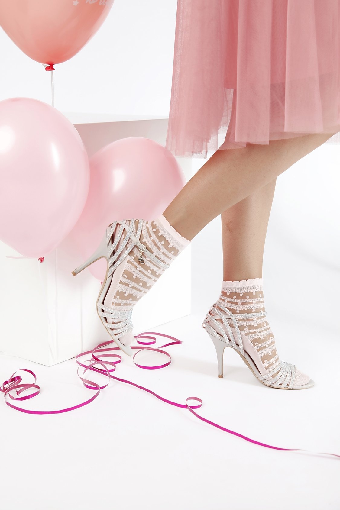 Elegant sheer light pink socks for women with a lacy pattern, made from 100% polyamide, perfect for stylish outfits.