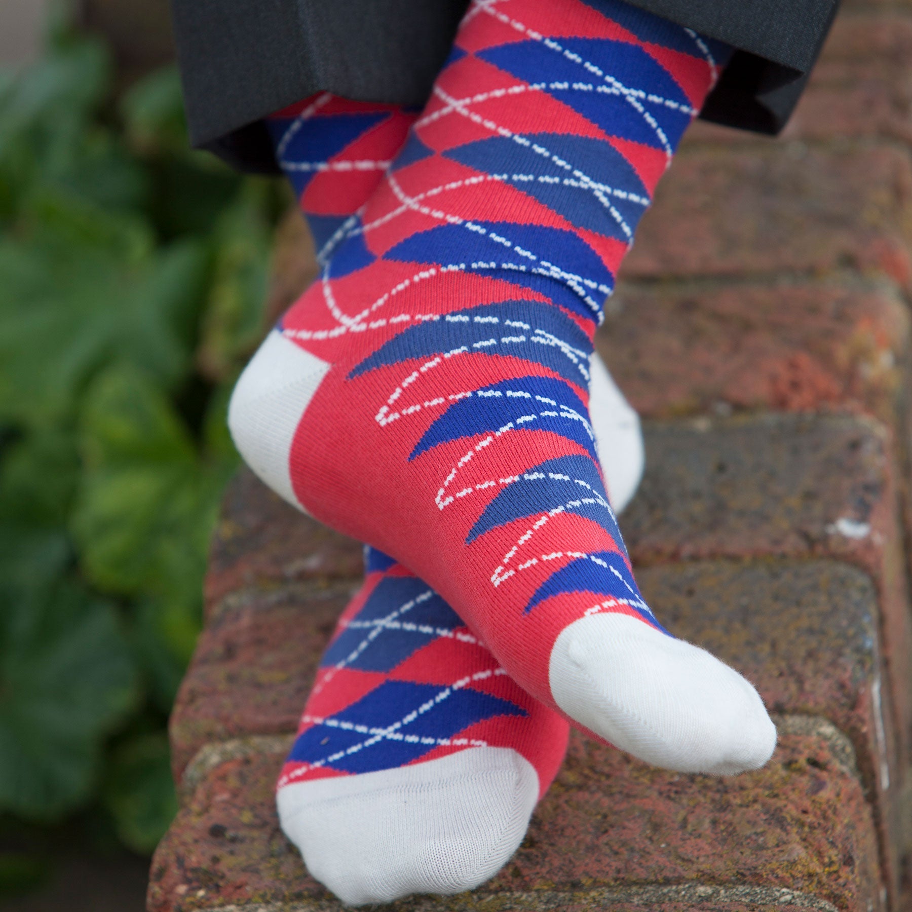 Argyle Men's Socks in Crimson featuring a vibrant red and blue pattern with grey cuff, heel, and toe, made from luxurious Supima cotton.