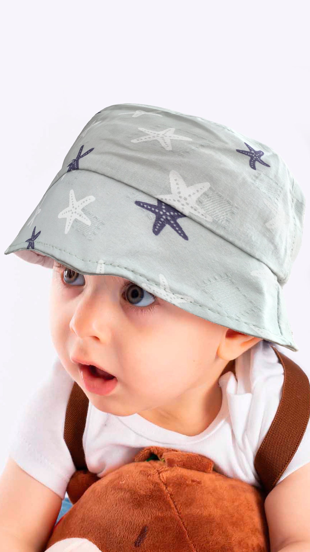 Sierra baby and toddler bucket hat in blue with a star print, made from soft cotton and polyester, designed for ages 1-3 years.