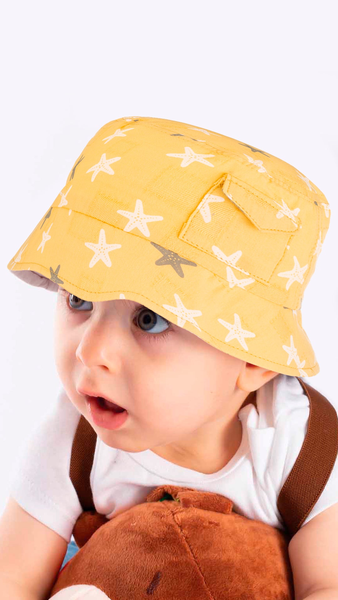 Sierra baby and toddler bucket hat in blue with a star print, made from soft cotton and polyester, designed for ages 1-3 years.