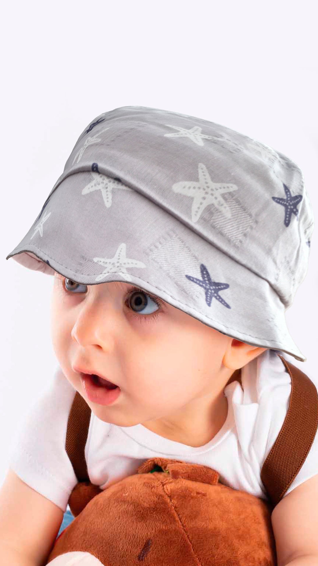 Sierra baby and toddler bucket hat in blue with a star print, made from soft cotton and polyester, designed for ages 1-3 years.