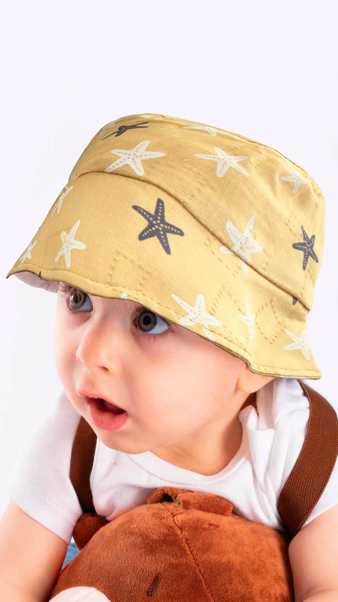 Sierra baby and toddler bucket hat in blue with a star print, made from soft cotton and polyester, designed for ages 1-3 years.