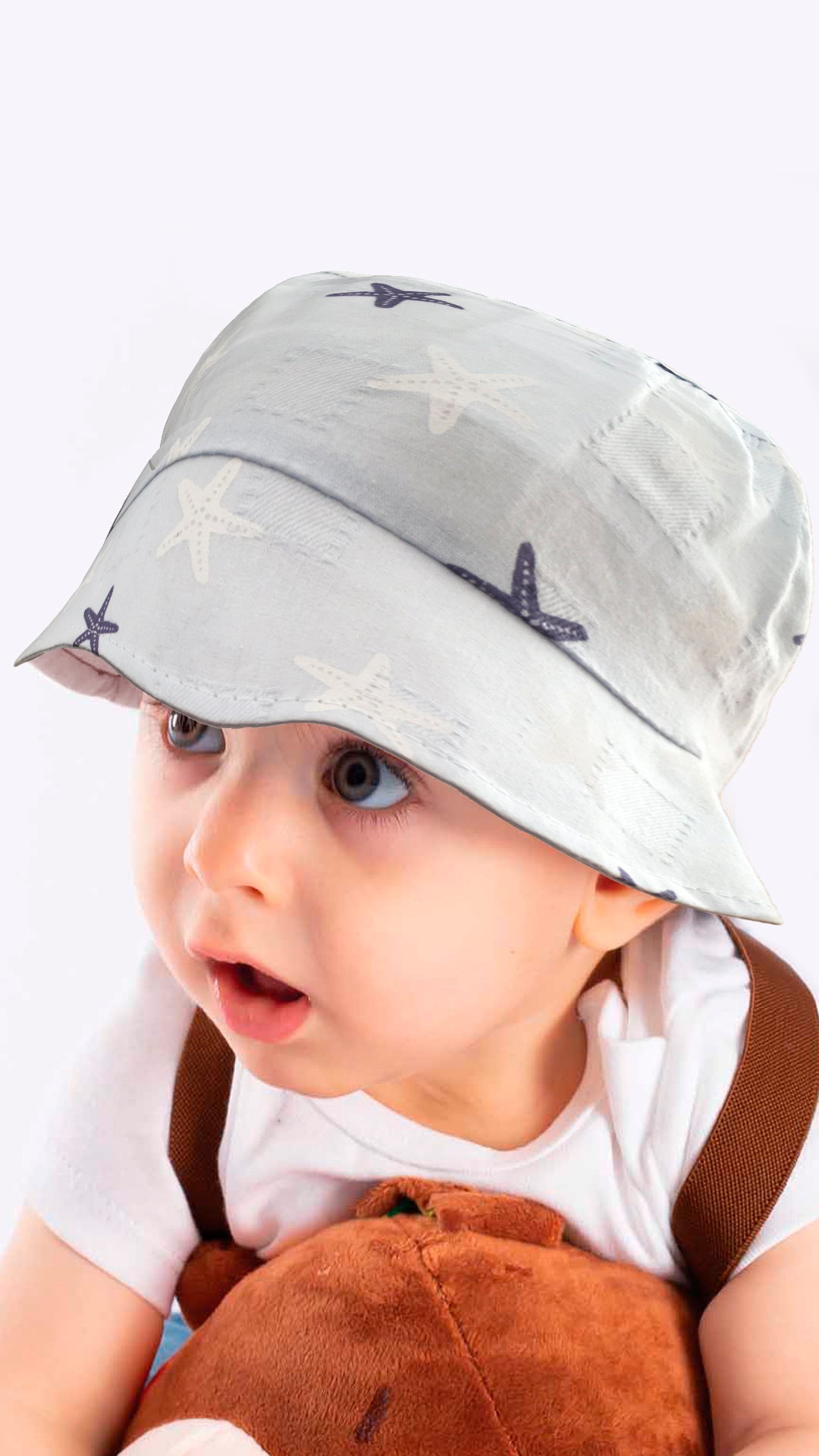 Sierra baby and toddler bucket hat in blue with a star print, made from soft cotton and polyester, designed for ages 1-3 years.