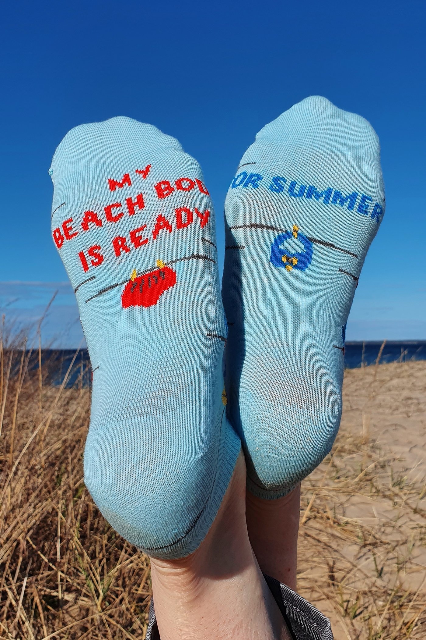 Light blue cotton socks for women with a knitted pattern and motivational writing on the sole, perfect for summer.