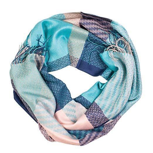 A luxurious blue checkered shawl made from baby alpaca wool and silk, elegantly draped to showcase its soft texture and sophisticated design.