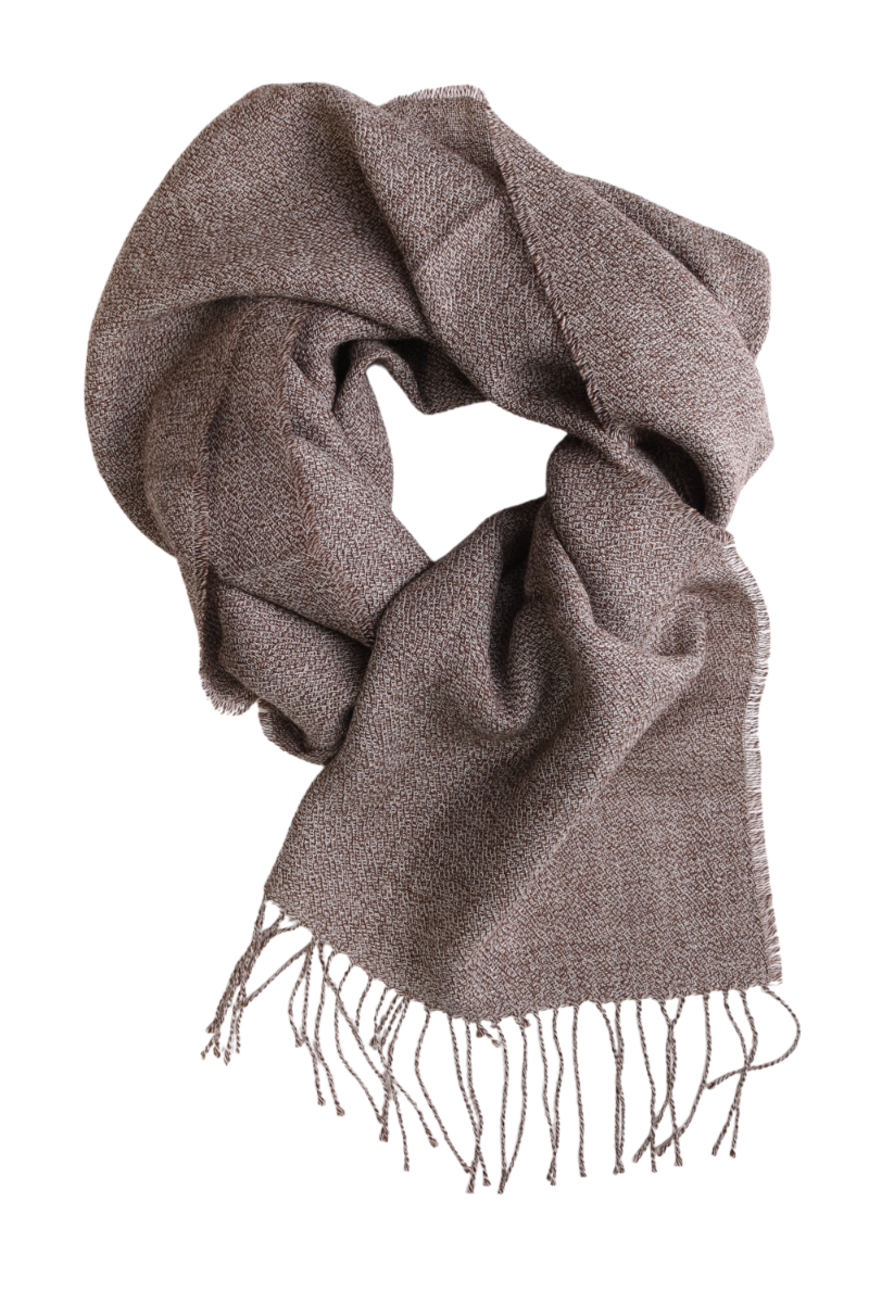 A luxurious brown ruffled alpaca wool scarf draped elegantly, showcasing its soft texture and stylish design.