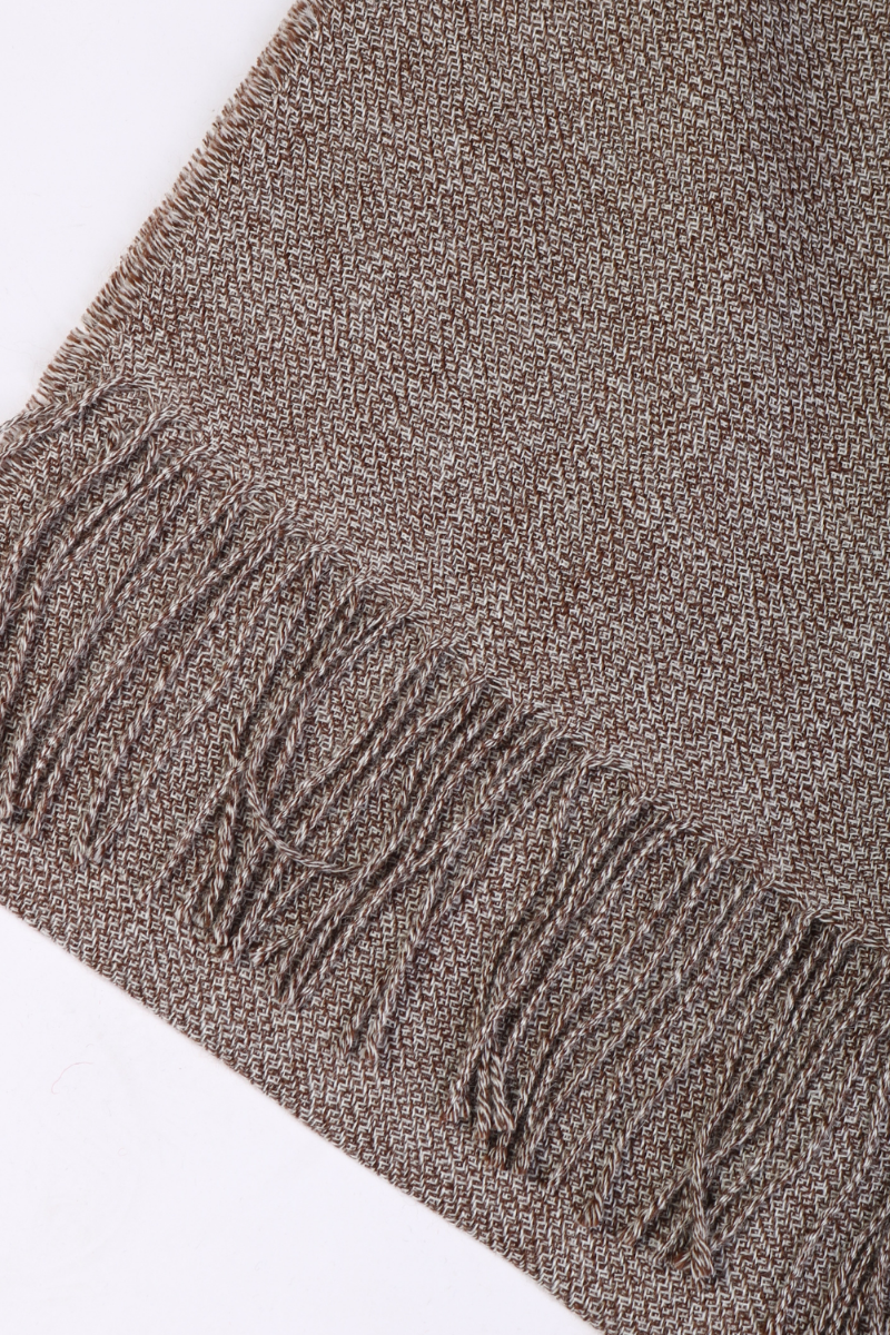 A luxurious brown ruffled alpaca wool scarf draped elegantly, showcasing its soft texture and stylish design.