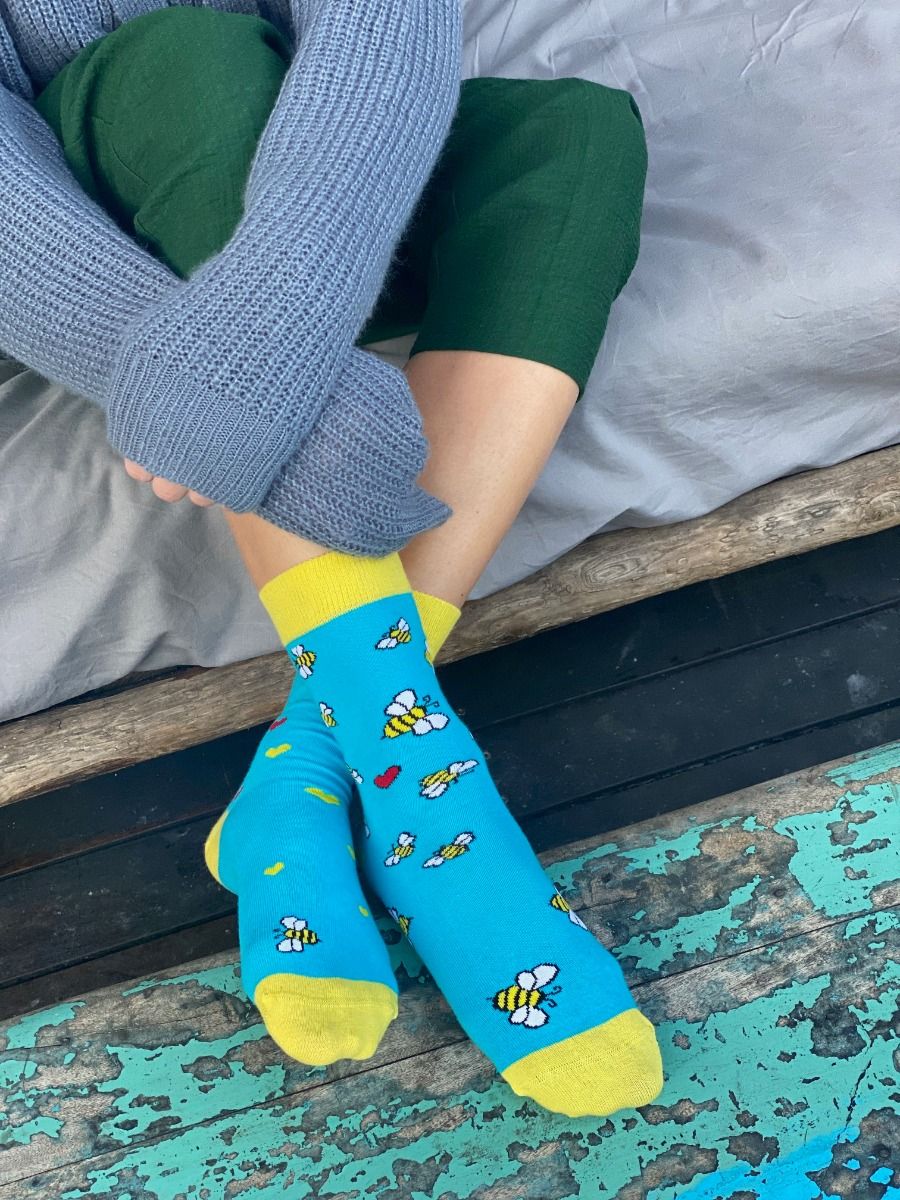 Light blue BUZZ socks featuring playful bees and hearts, perfect for Valentine's Day gifts.