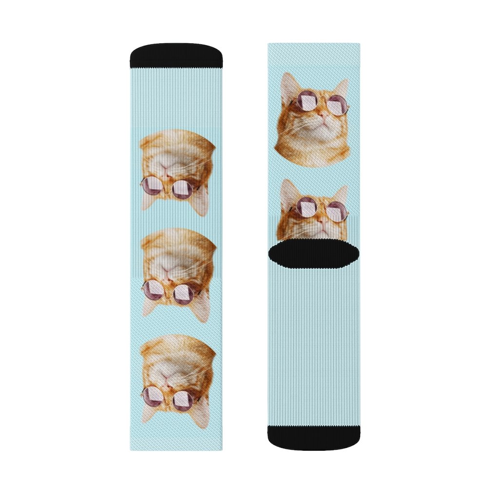 A pair of stylish socks featuring a playful cat wearing sunglasses, showcasing vibrant colors and a fun design.