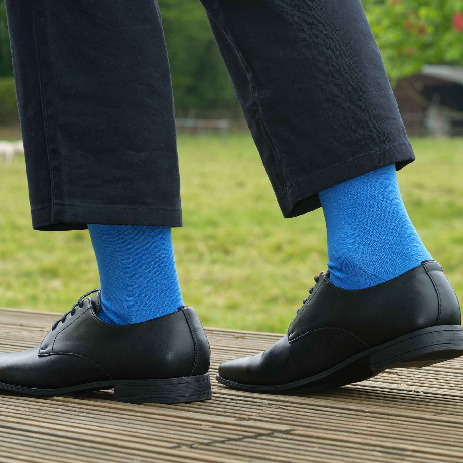 A pair of vibrant blue classic men's socks made from luxurious Mercerised Egyptian cotton, showcasing a seamless toe design.