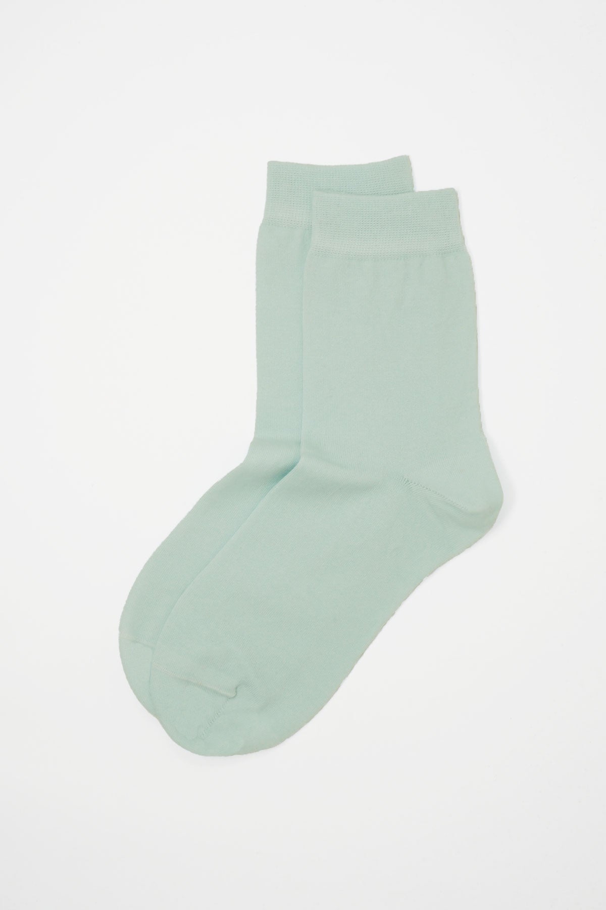 A pair of classic women's socks in baby blue, made from luxurious Mercerised Egyptian cotton, showcasing a seamless toe design.