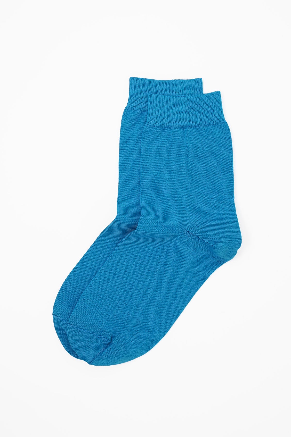 A pair of classic women's socks in vibrant blue, made from luxurious Egyptian cotton, showcasing a seamless toe design.