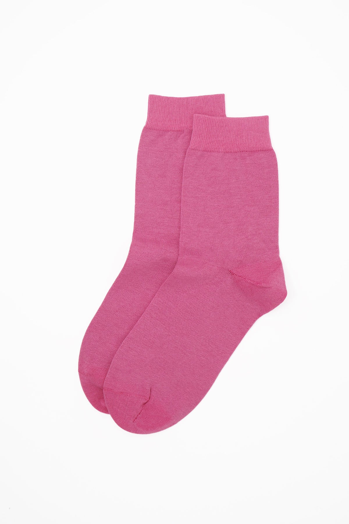 A pair of vibrant pink classic women's socks made from luxurious Egyptian cotton, showcasing a seamless toe design.