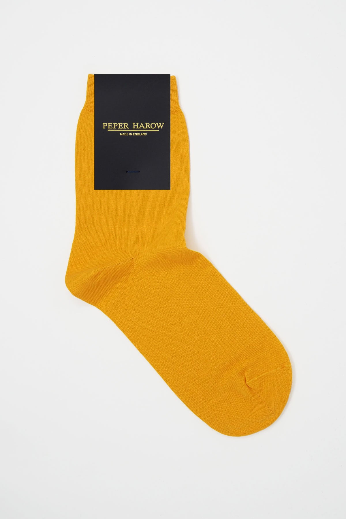 A pair of vibrant yellow classic women's socks made from luxurious Egyptian cotton, showcasing a seamless toe design.