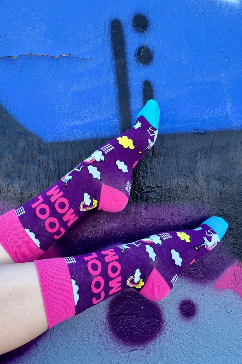 COOL MOM purple socks featuring unicorns and rainbows, perfect for adventurous mothers.