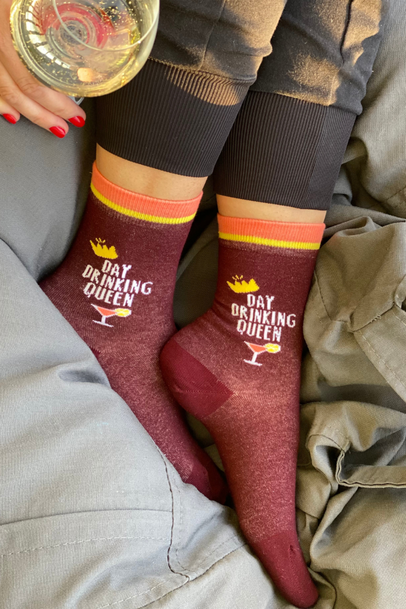 Burgundy socks for women featuring a cocktail glass design and the text 'DAY DRINKING QUEEN' on the side.