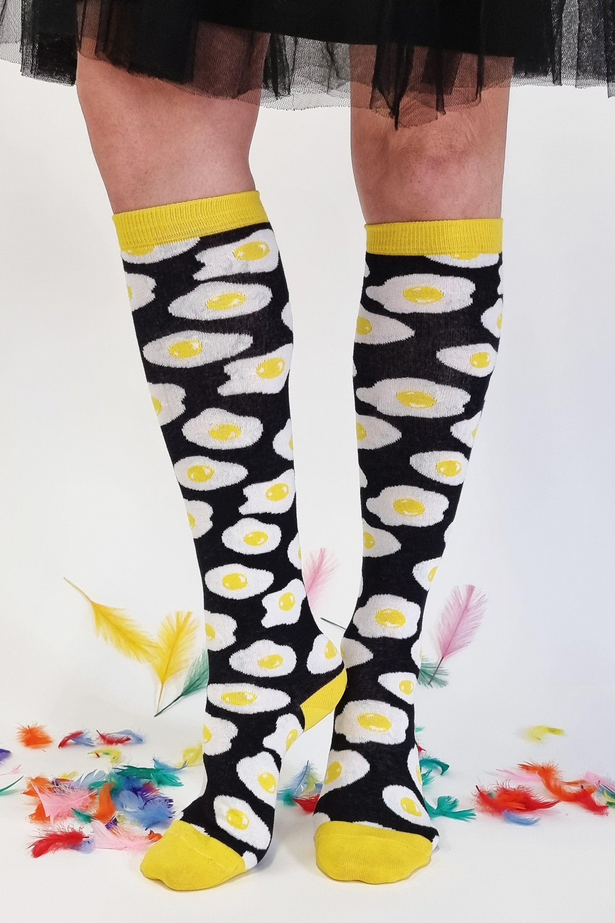 Black and yellow cotton knee-high socks featuring a sunny side up egg design, perfect for men and women.