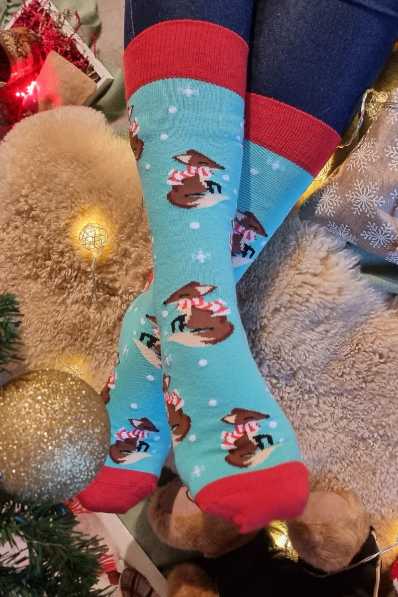 A pair of blue cotton socks featuring cute fox designs, perfect for cozy wear during winter.