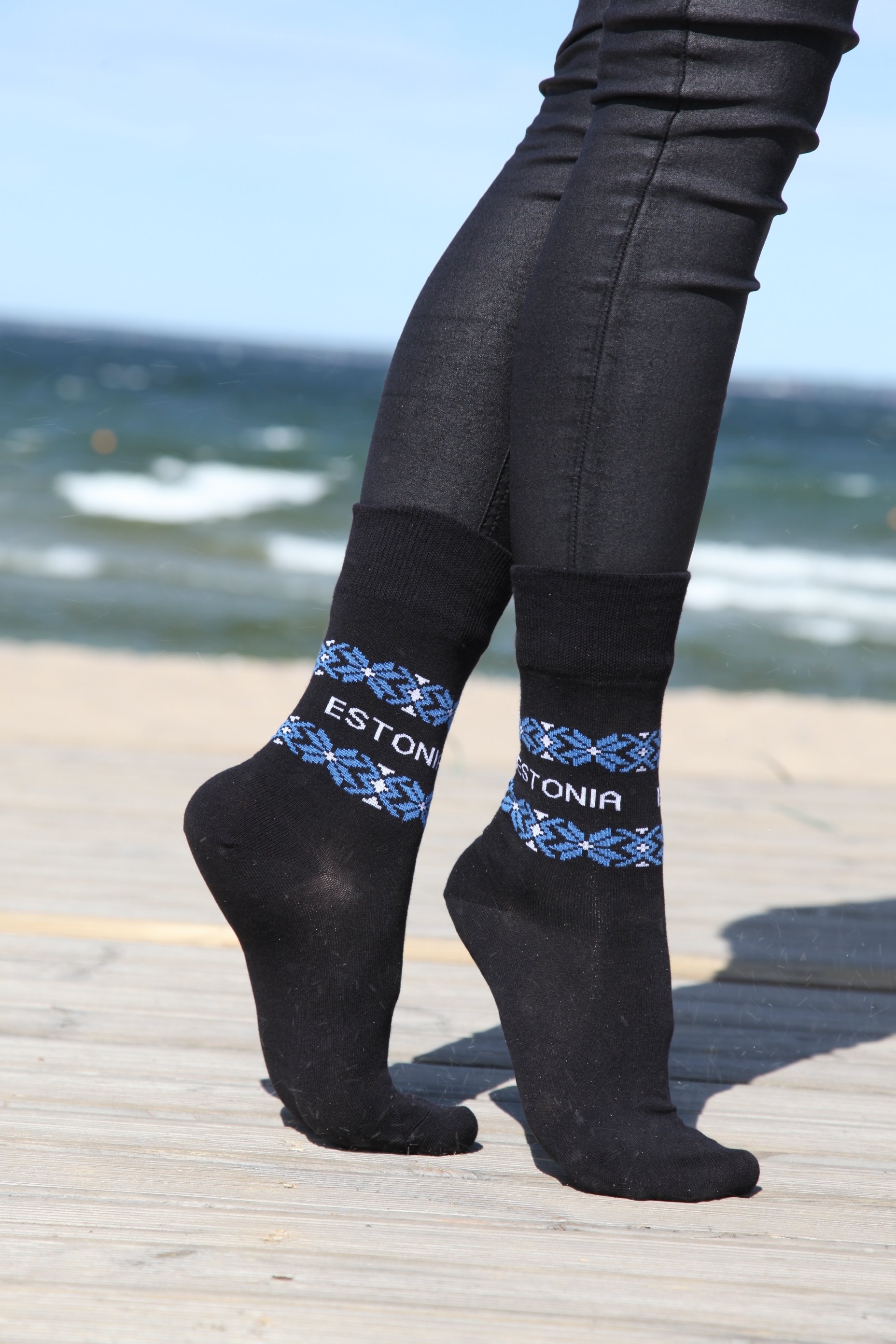 Black ESTLAND cotton socks featuring Estonia design with 'ESTONIA' written on them, suitable for men and women.