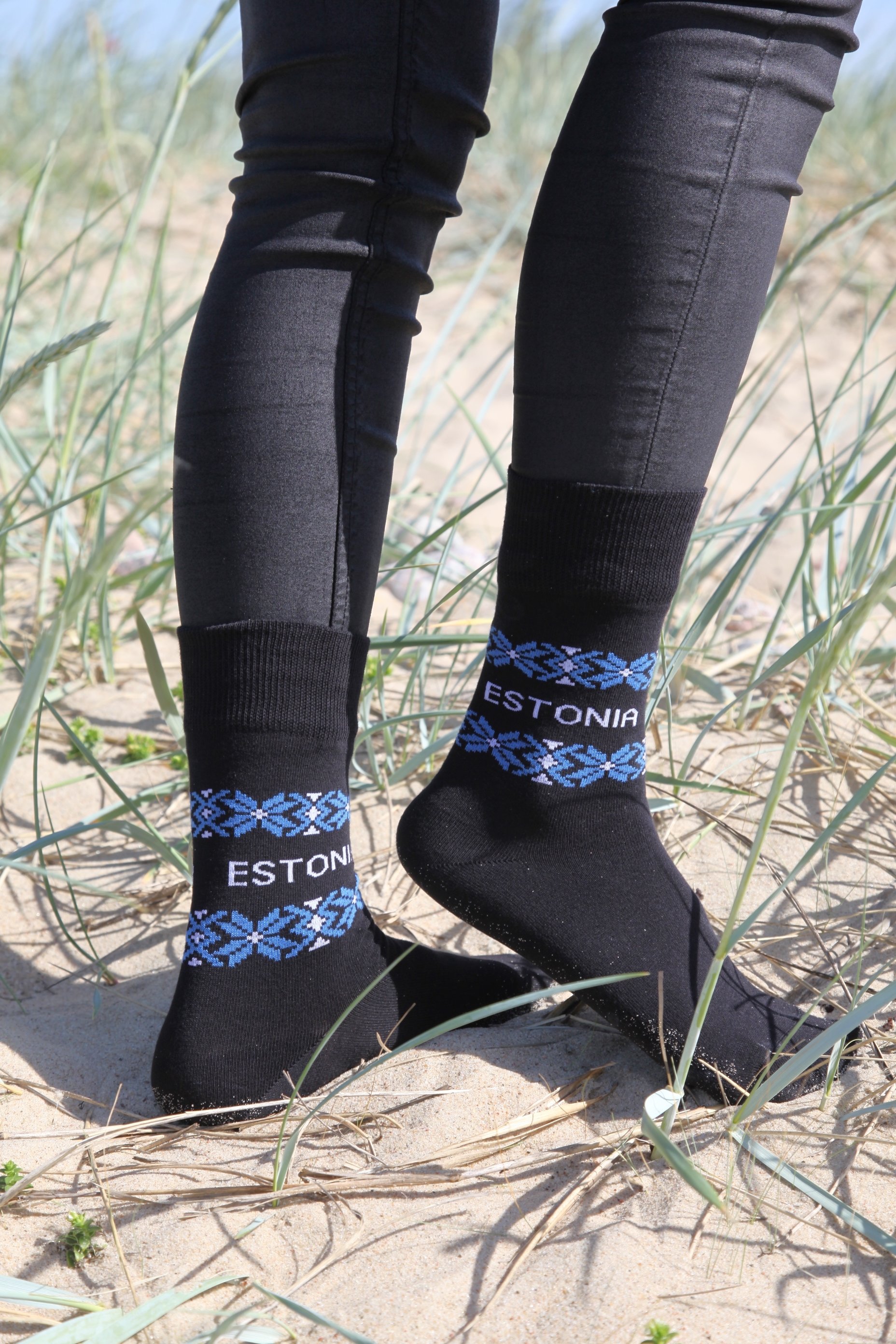 Black ESTLAND cotton socks featuring Estonia design with 'ESTONIA' written on them, suitable for men and women.