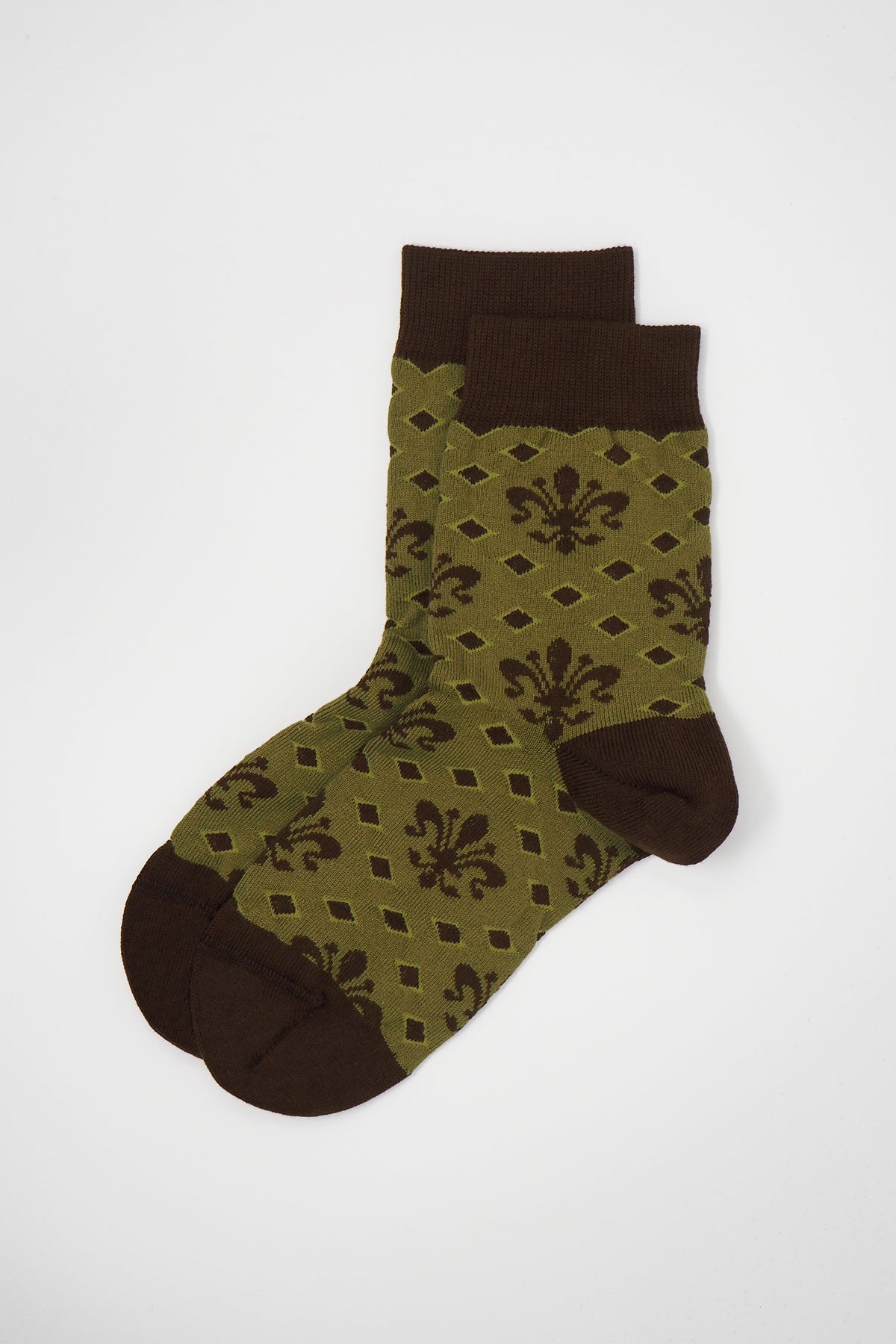 A pair of green Fleur De Lis women's socks made from luxurious Supima cotton, featuring an elegant design and seamless toe.