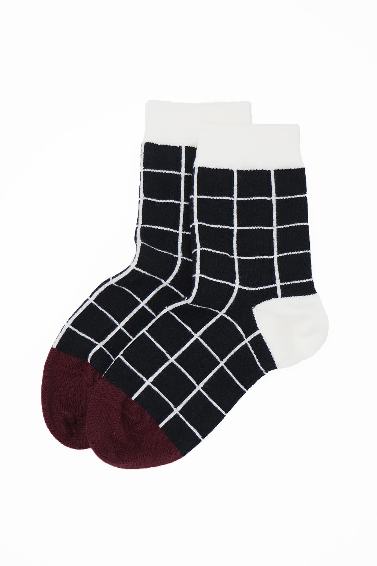 A pair of elegant black Grid Women's Socks featuring a symmetrical grid design, made from luxurious Supima cotton.