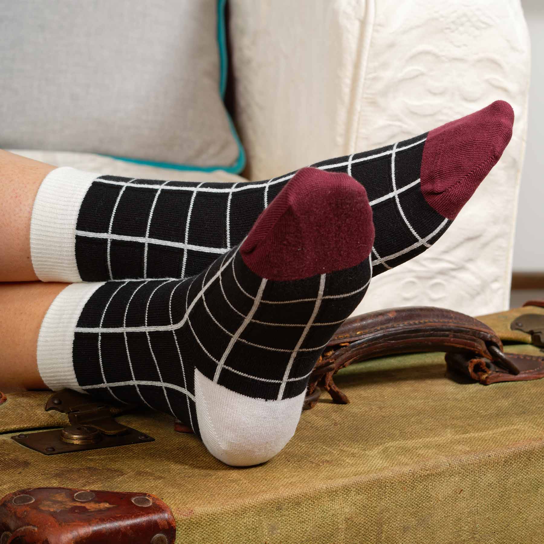 A pair of elegant black Grid Women's Socks featuring a symmetrical grid design, made from luxurious Supima cotton.