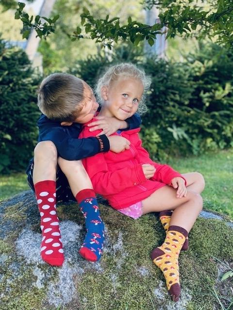 A pair of yellow cotton socks for children featuring a cute knitted hedgehog pattern, perfect for comfort and style.