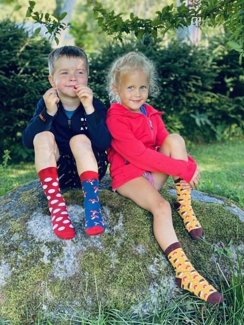 A pair of yellow cotton socks for children featuring a cute knitted hedgehog pattern, perfect for comfort and style.