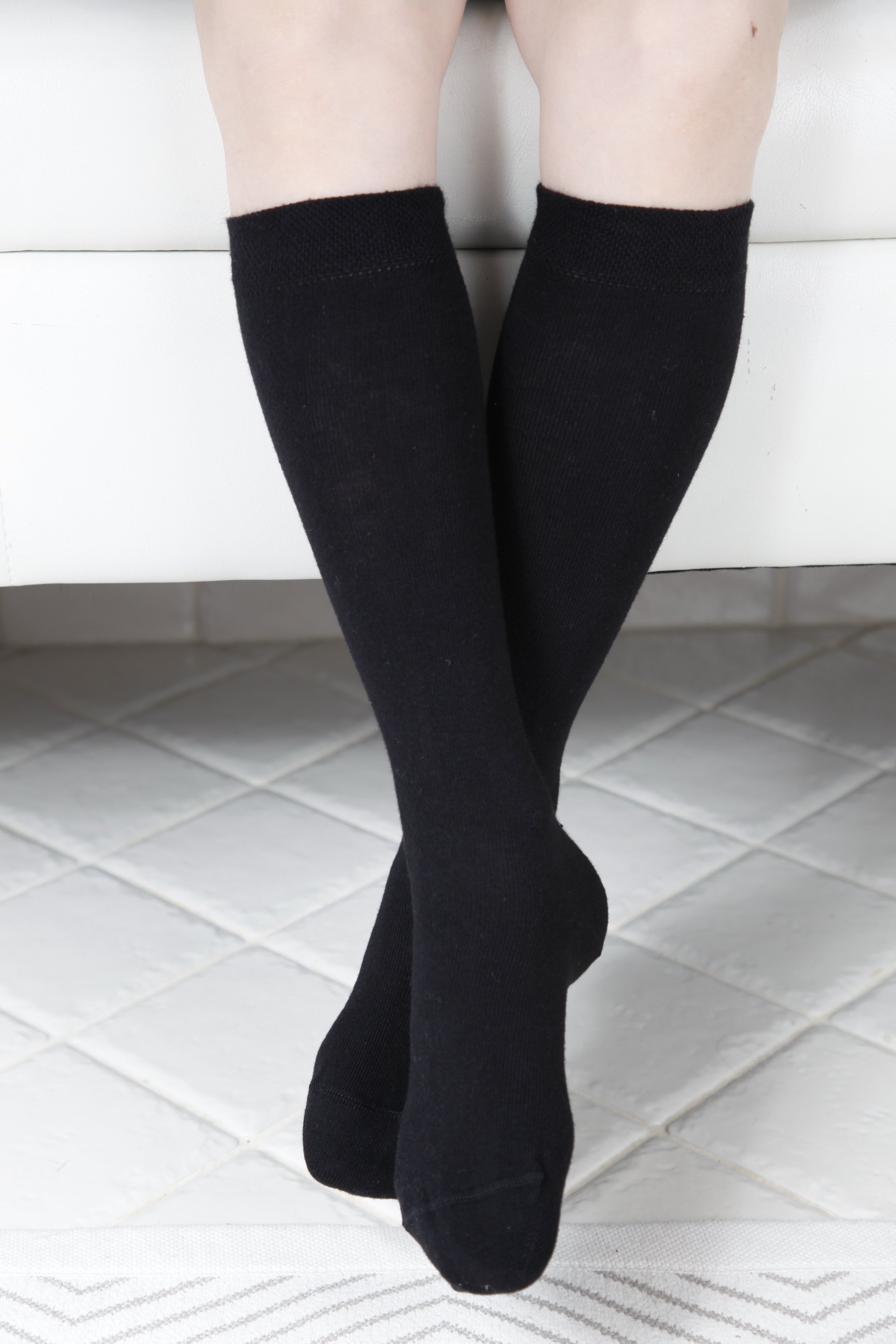 KRISS black cotton knee high socks for children, showcasing their soft texture and stretchy design.