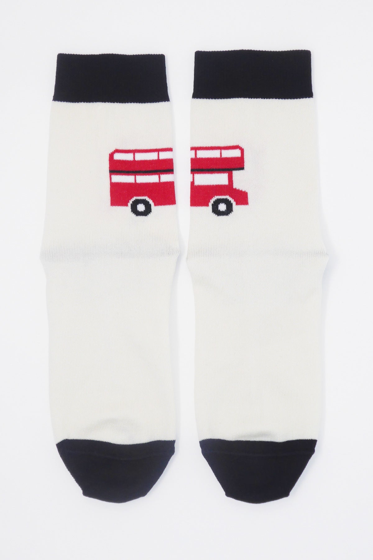 Cream women's socks featuring an iconic London red bus design, showcasing luxury and comfort.