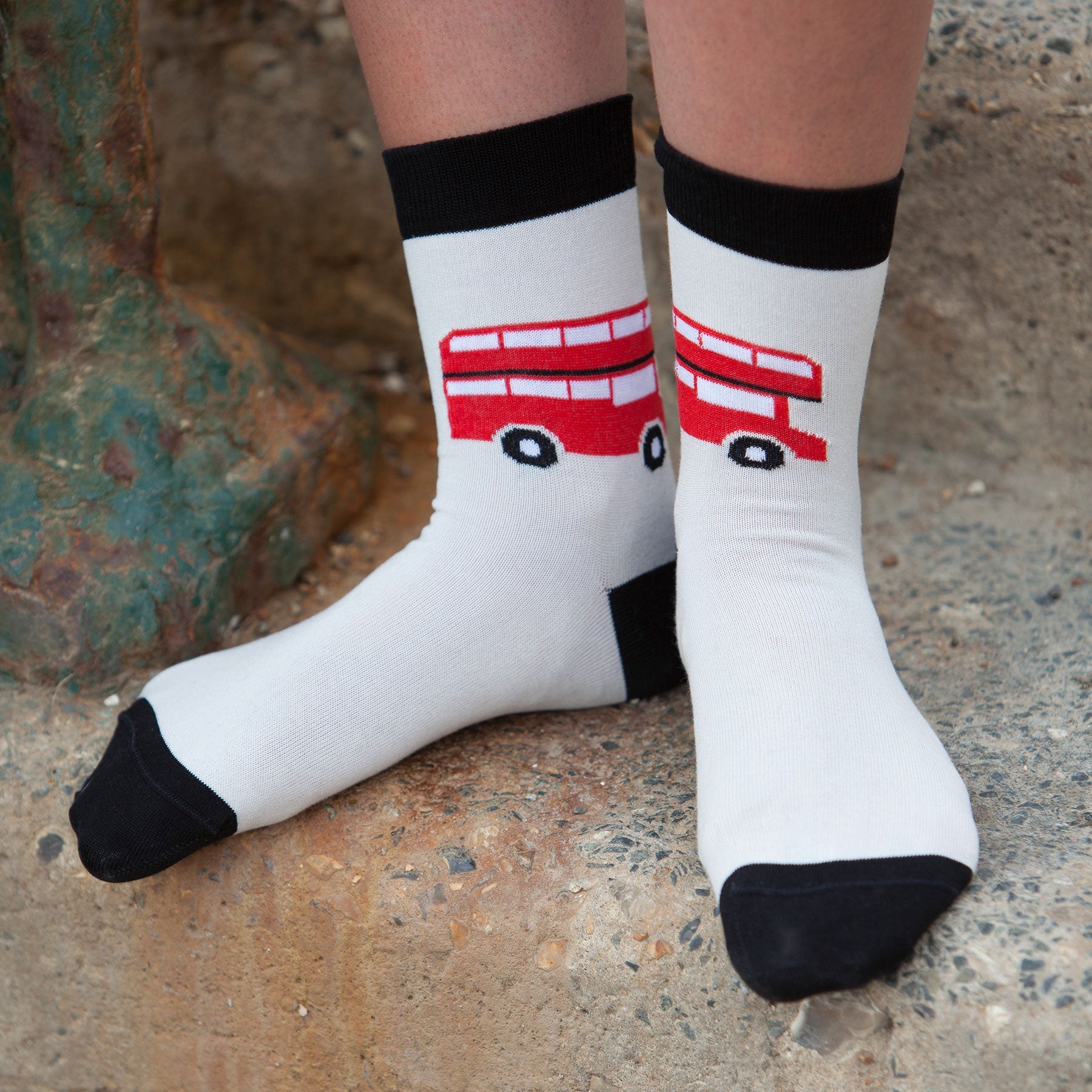 Cream women's socks featuring an iconic London red bus design, showcasing luxury and comfort.