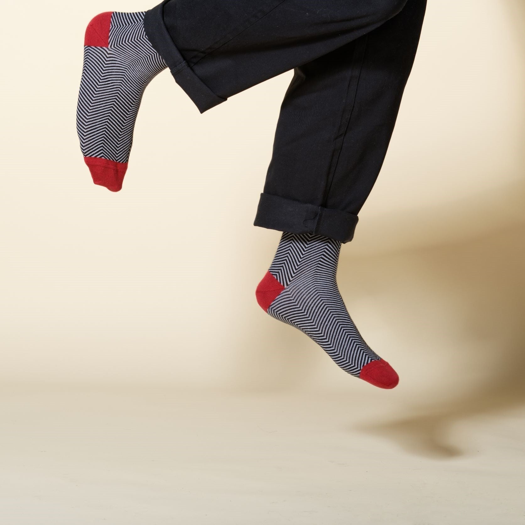 Lux Taylor Men's Socks in black with white zigzag pattern and red heel and toe, showcasing luxury and style.