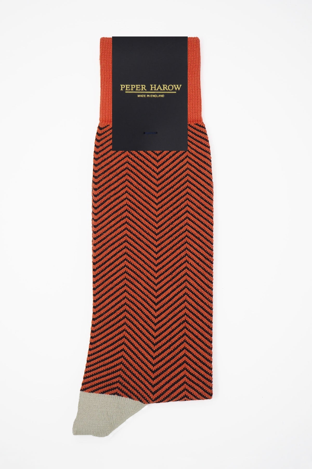 Lux Taylor Men's Socks in vibrant orange with black zigzag pattern and cream heel and toe, showcasing luxury and style.