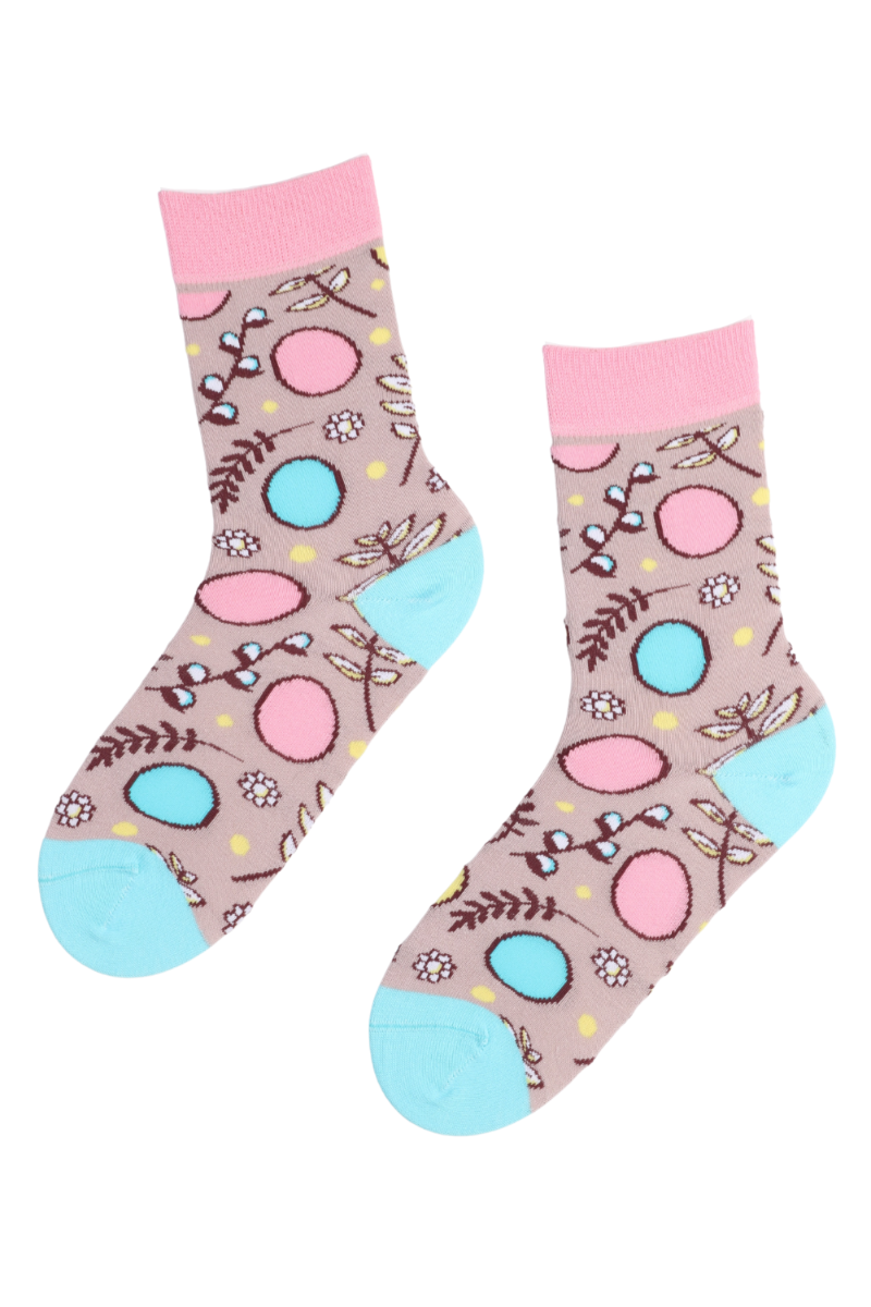 NEST pink Easter socks featuring colorful eggs, flowers, and willow catkins on a soft old-pink background.