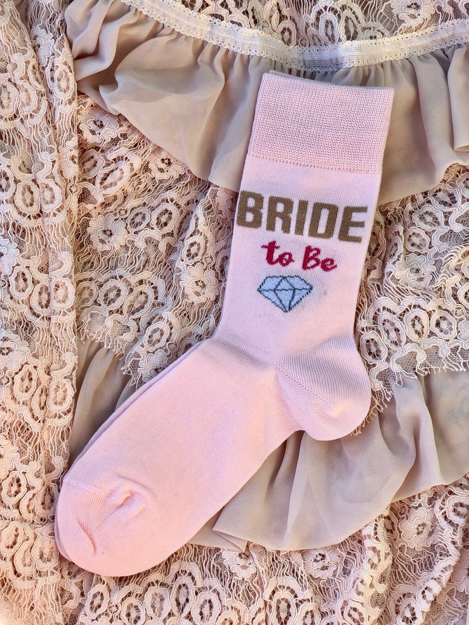 Cozy pink women's socks with 'Bride to Be' text, perfect for bridal celebrations.