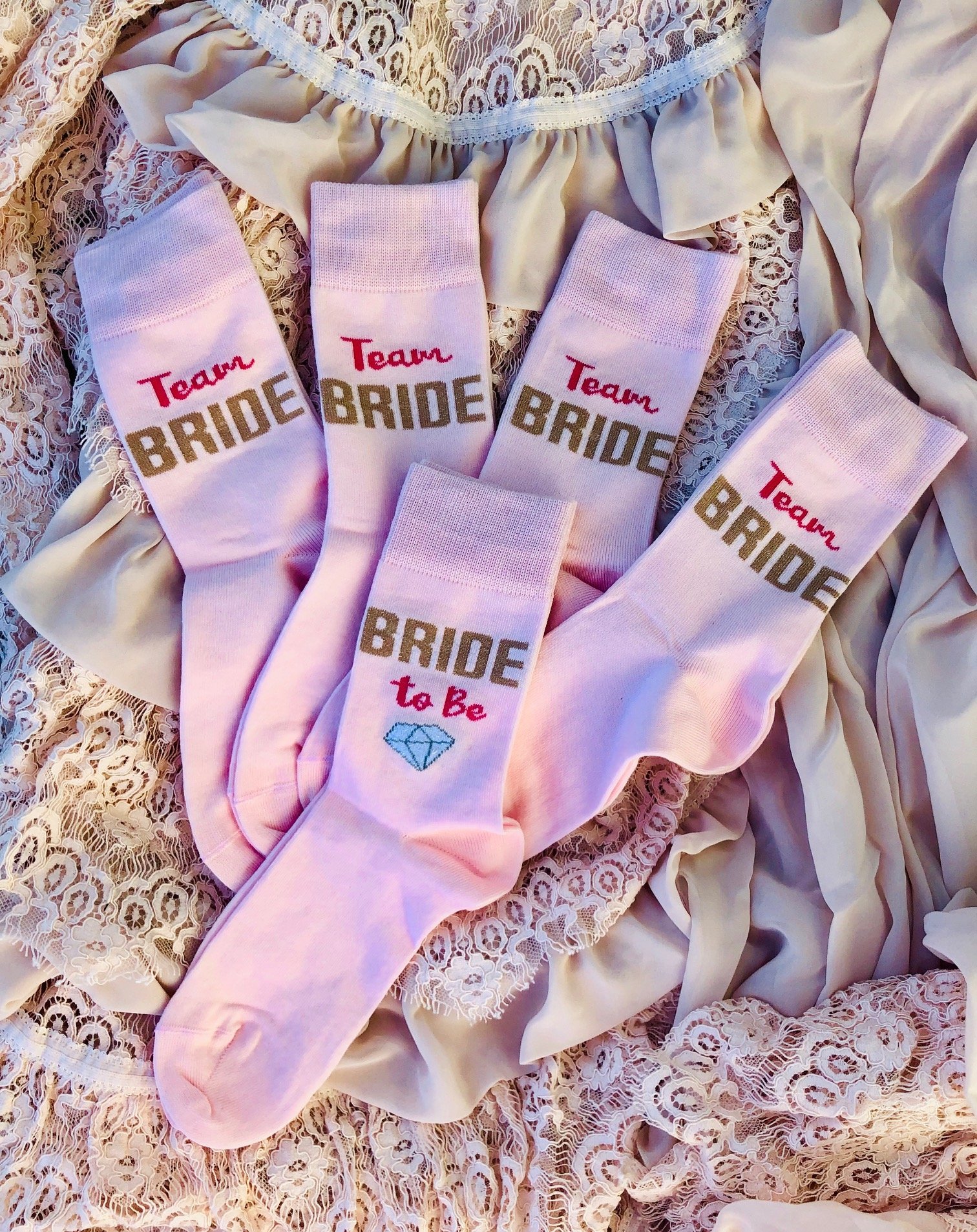 Cozy pink women's socks with 'Bride to Be' text, perfect for bridal celebrations.