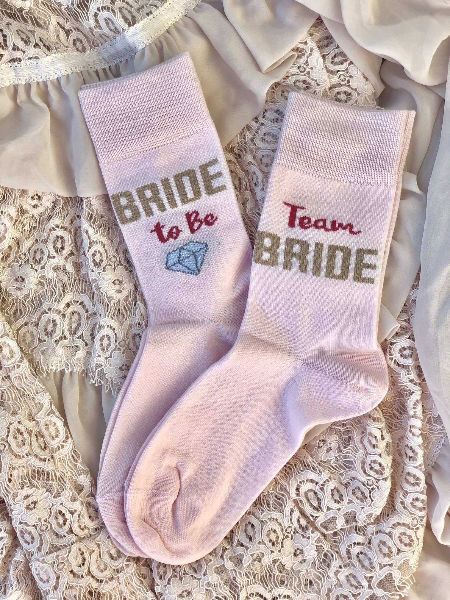 Cozy pink women's socks with 'Bride to Be' text, perfect for bridal celebrations.