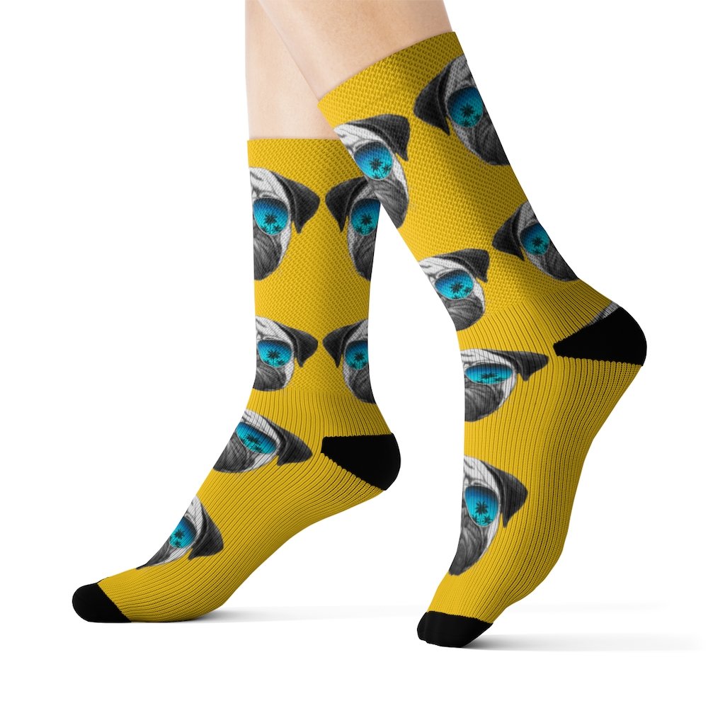 A pair of fun novelty socks featuring a cute Pug wearing sunglasses, showcasing a vibrant and playful design.