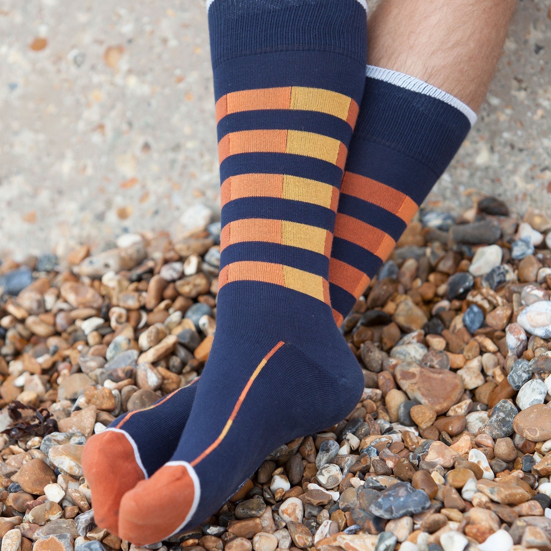 Navy Quad Stripe men's luxury socks with contrasting orange and yellow stripes, showcasing a stylish design for gentlemen.