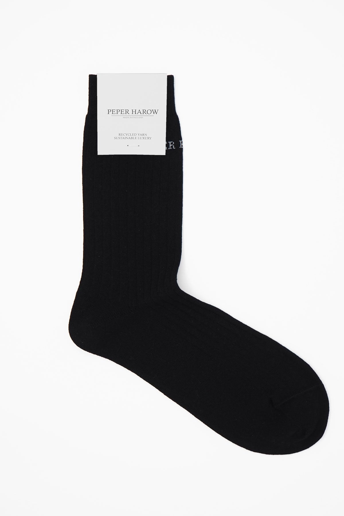 A pair of black ribbed women's socks made from recycled materials, showcasing their eco-friendly design and seamless toe.